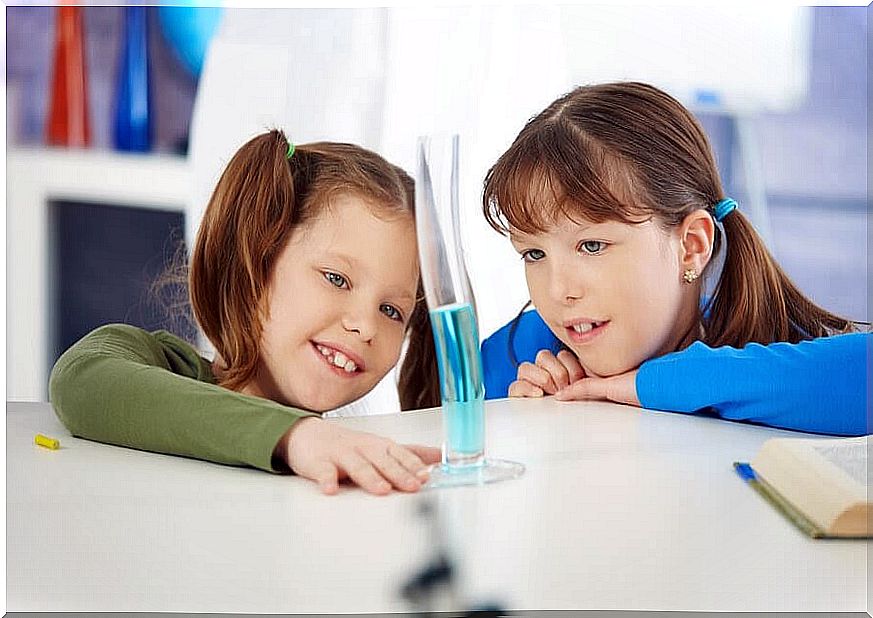 Two children perform experiments with water