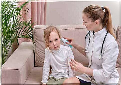 afraid of the doctor: doctor takes the temperature in the ear of children