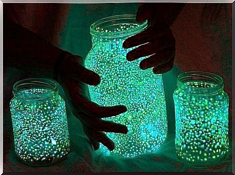 Hands holding a luminous lamp.