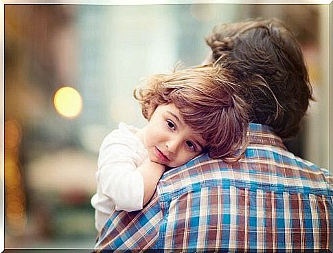 Dad carrying children