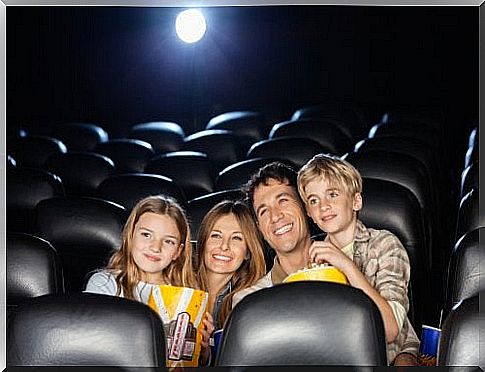 Family sitting in cinema.