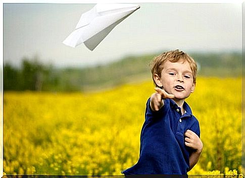 Boy throws paper airplanes