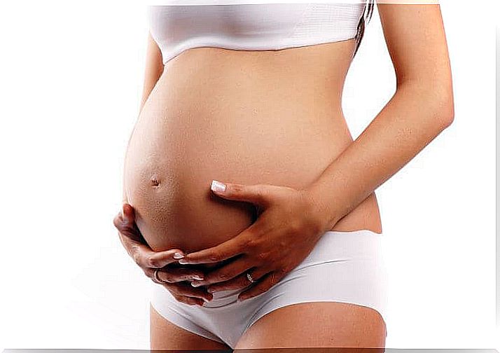 Pregnant woman holding her belly