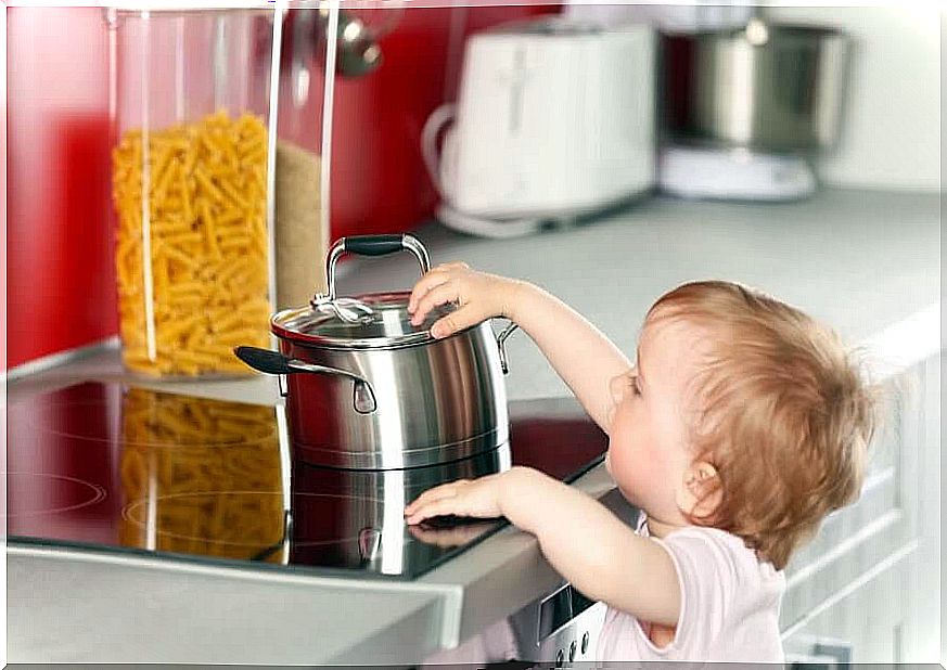 toddlers reach for saucepan on stove