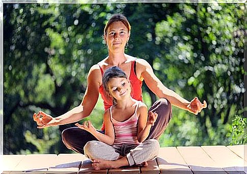 Mother and daughter doing relaxation exercises.