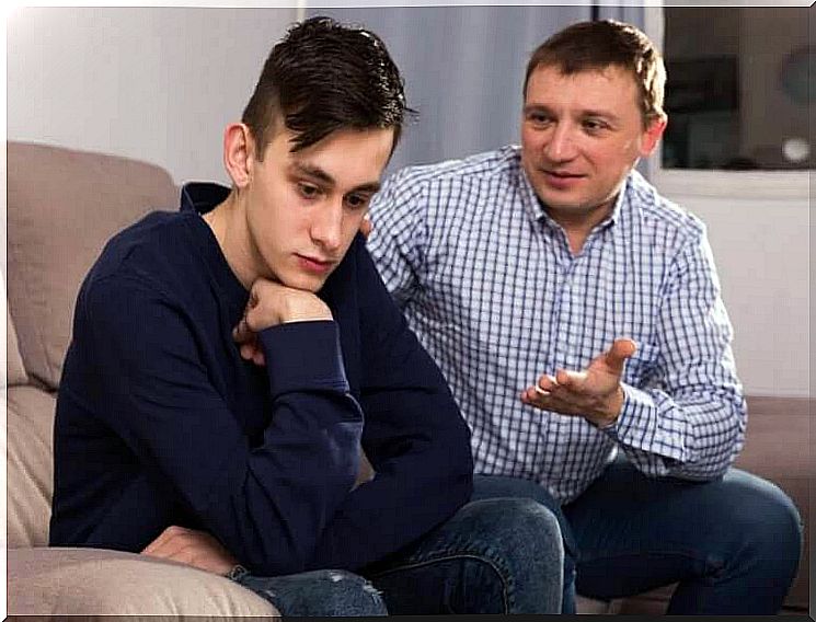 Communicate with teens: dad and teen son on couch