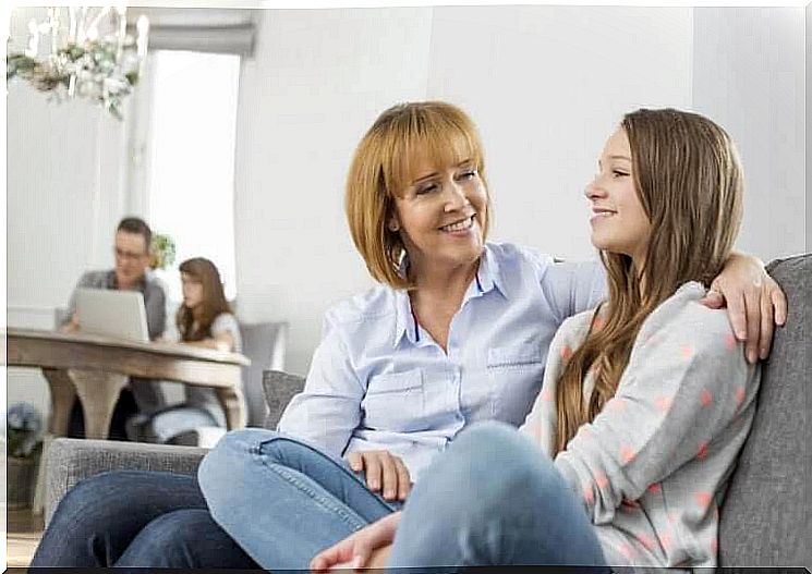 Communicate with teenagers: mother and teenage daughter on sofa