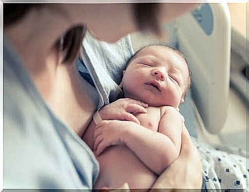 Newborn baby in mother's arms