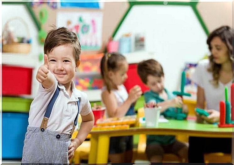 preschool history: boy in preschool environment gives a thumbs up