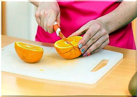 Avoid while breastfeeding: Woman cuts up an orange