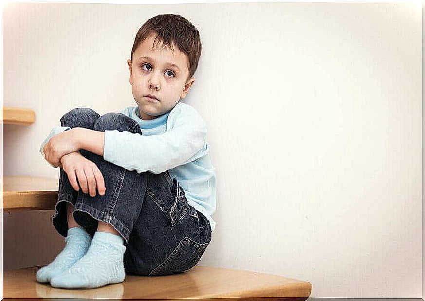 depressed boy sitting on the floor