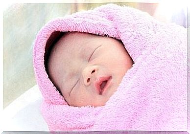 Sleeping newborn in blanket