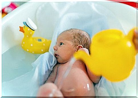 A newborn baby is bathed