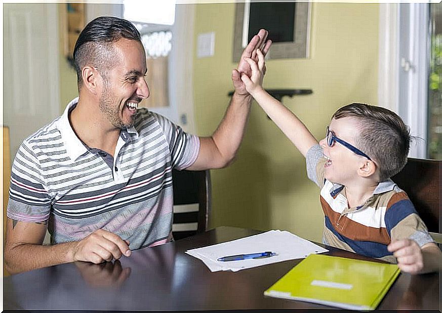 Man and boy do high five over homework