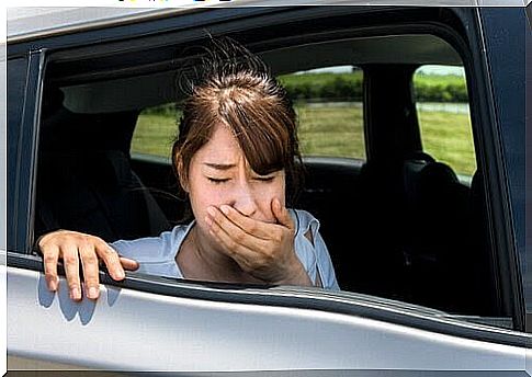 girl in car looks nauseous