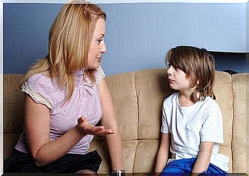 say "no": mother and child discussing on sofa