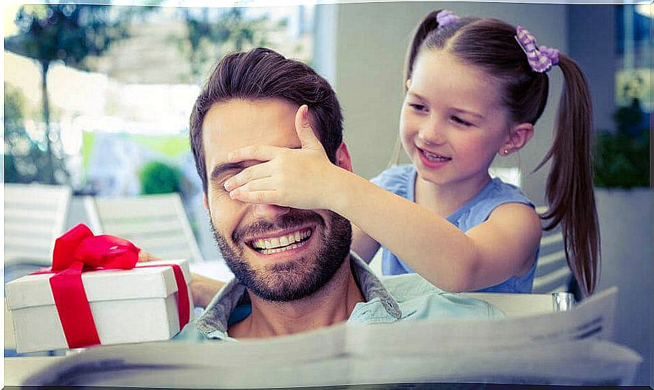 girl gives dad a present and keeps an eye on him