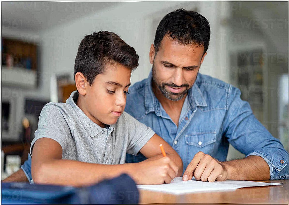 Father helps son with homework.