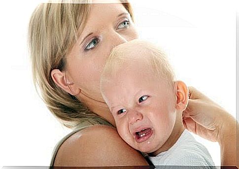 Woman carrying crying baby