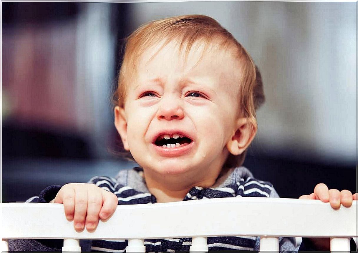 A baby crying in his crib.