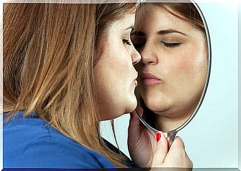 woman kissing her reflection