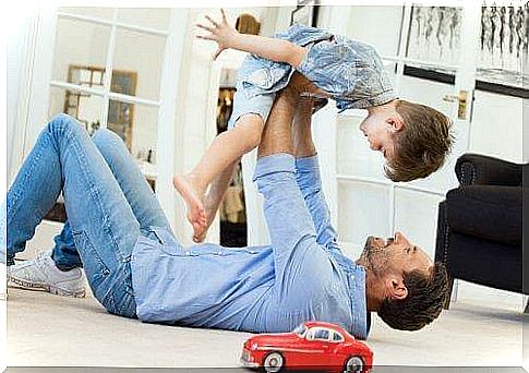 Dad plays airplane with his child.