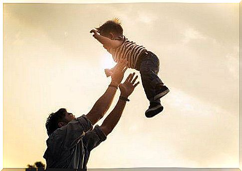 Dad throws his baby in the air.