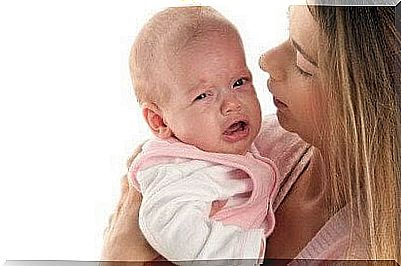 mother comforts crying baby