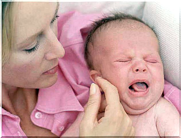 mother comforts crying baby