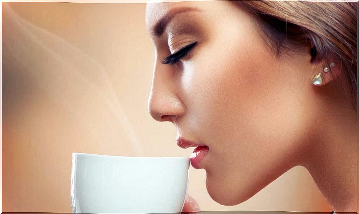 woman drinking a cup of coffee with eyes closed