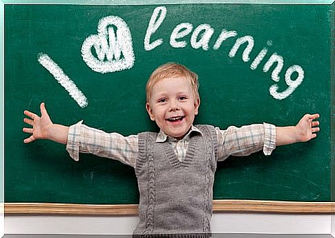 happy boy in front of blackboard