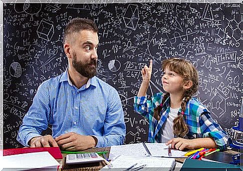 kumon method: teacher looks at student with hand in air