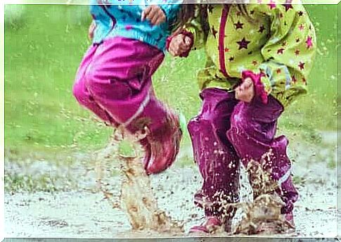 children jumping in pool of water