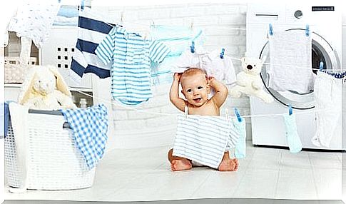 Baby playing with laundry