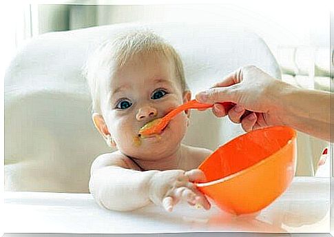 baby is fed with baby food