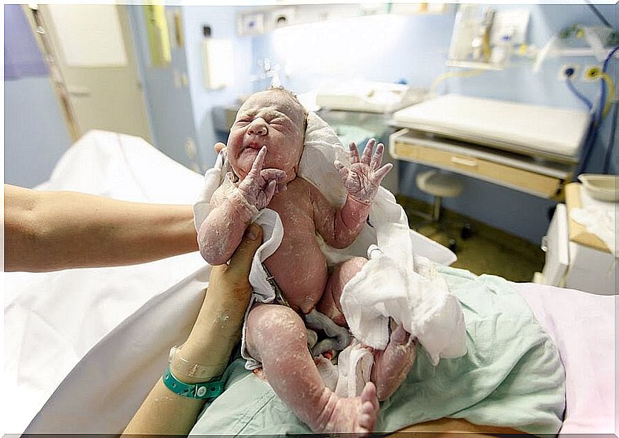 newborn baby with umbilical cord left