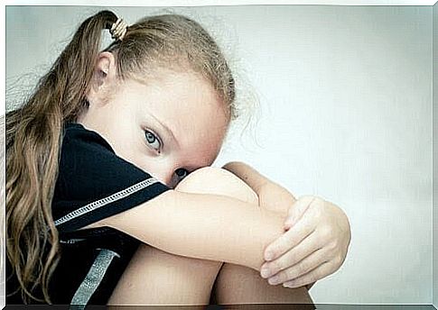 the wounds in the family: girl sitting crouched